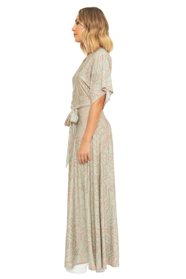 Side profile of the BlackMilk Elves of Middle-Earth Maxi Dress, showing the flowing kimono sleeves and floor-length silhouette in sage green Elvish-inspired print.