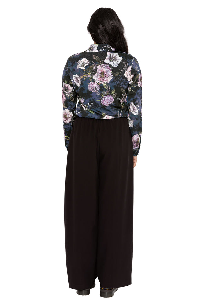 Dark academia button-up shirt with moody floral artwork and subtle hidden insects woven through a gothic botanical print. This corporate goth top combines alternative office fashion and modern witch aesthetics with a relaxed silhouette and fitted sleeves.