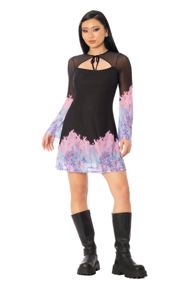 Model wearing the black dress with sheer flared sleeves and pink and blue accents. League of Legends K/DA x BlackMilk black fitted mini dress with sheer flared sleeves and pink-to-blue printed detailing inspired by Ahri.