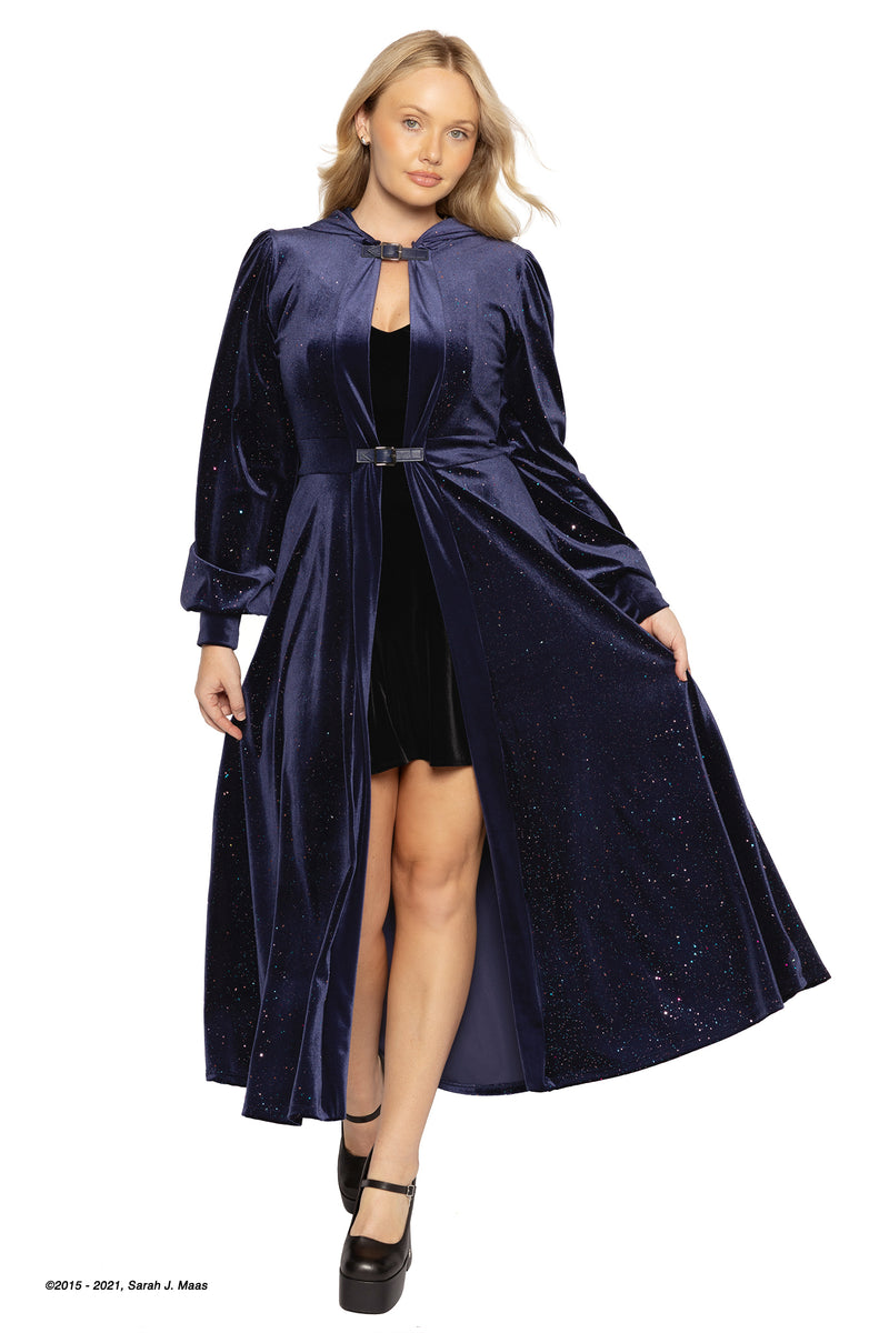 Model in a navy velvet hooded jacket with celestial starburst details, moving through low light as the fabric shimmers, inspired by A Court of Thorns and Roses (ACOTAR) and the Night Court sky.