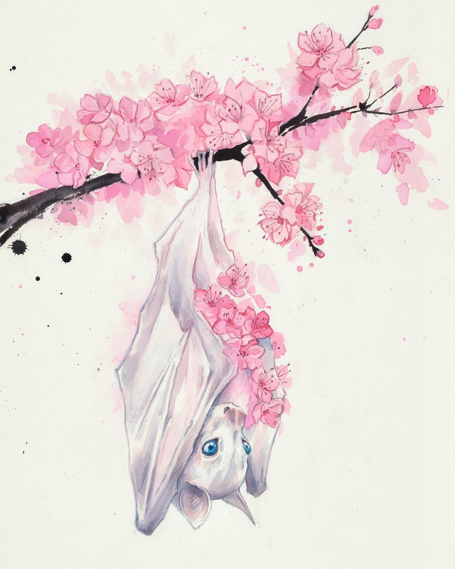 White bat hanging upside down from a cherry blossom branch on a white background
