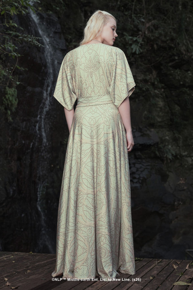 Close-up campaign shot of the Elves of Middle-Earth Maxi Dress by BlackMilk, showing the detailed Art Nouveau-style filigree print in sage green and blush.