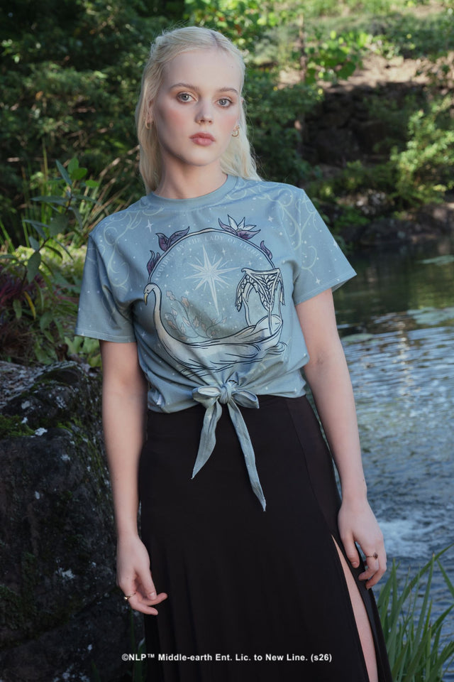 Close-up campaign shot of the Lady of Light Cotton Tie Front Tee by BlackMilk, showing the Galadriel-inspired celestial swan print in pale blue and silver.